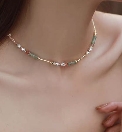 Model wearing bamboo pearl necklace with aventurine freshwater pearls and agate featuring green bamboo beads and delicate gold details