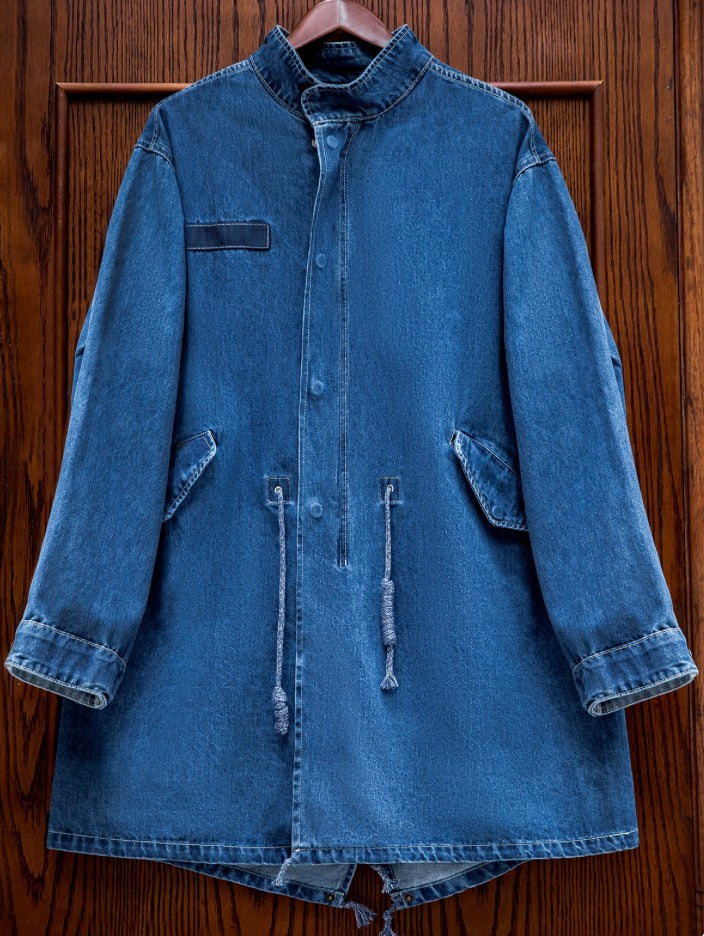 Indigo denim military jacket hanging on wood background