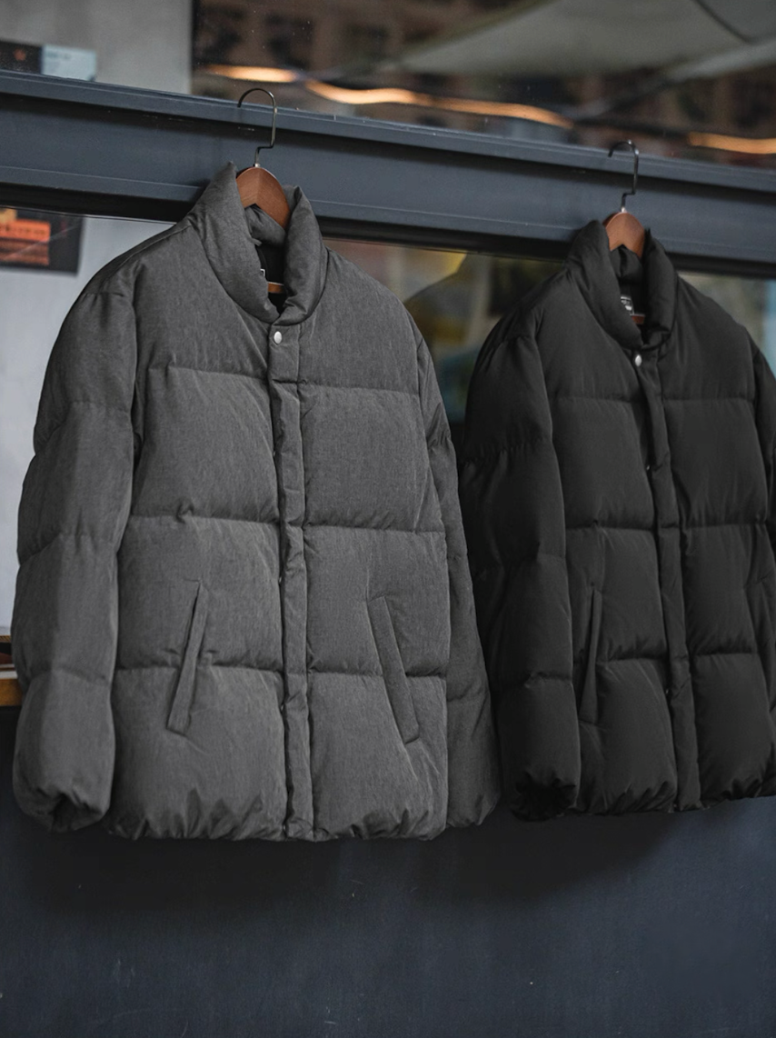 Grey and black Dual-Tone Down Jackets hanging side by side on rack