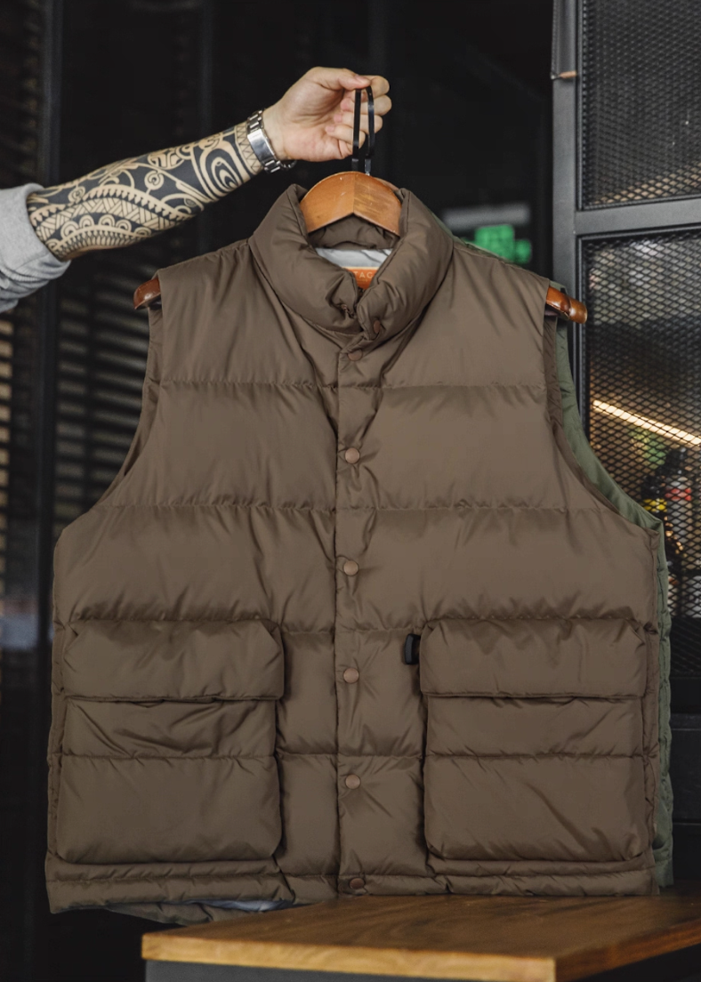 Mud Brown Heritage Down Vest hanging on hanger showing padded texture