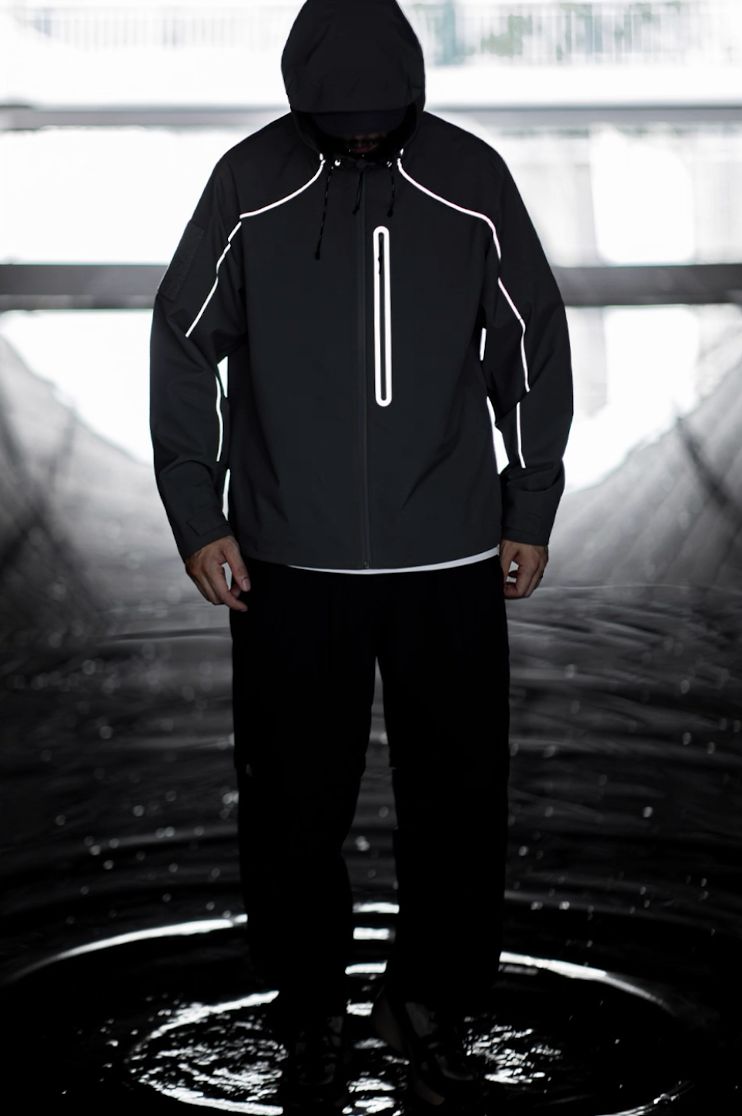 Black LIGHTSABER reflective jacket glowing under low light for night visibility