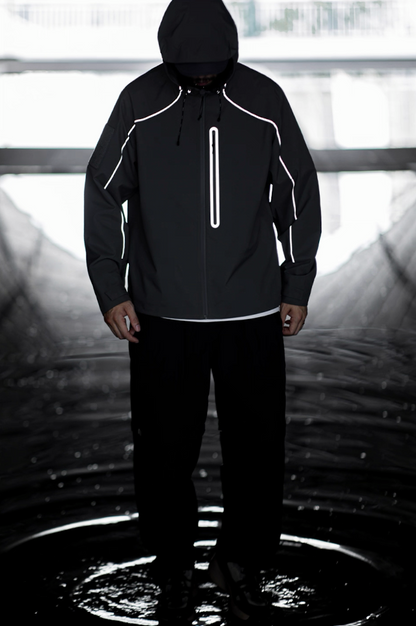 Black LIGHTSABER reflective jacket glowing under low light for night visibility