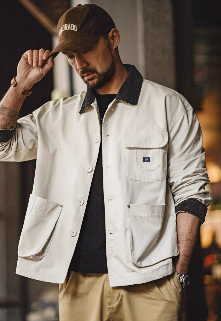 Man wearing Sand Beige canvas safari jacket with dark shirt and khaki pants