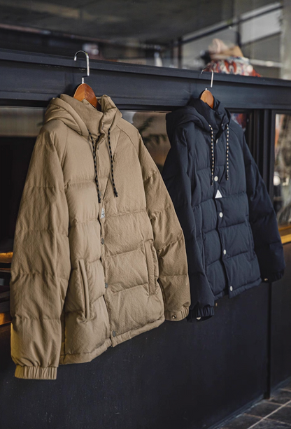 Khaki and dark blue Urban Shield Down Jackets hanging side by side