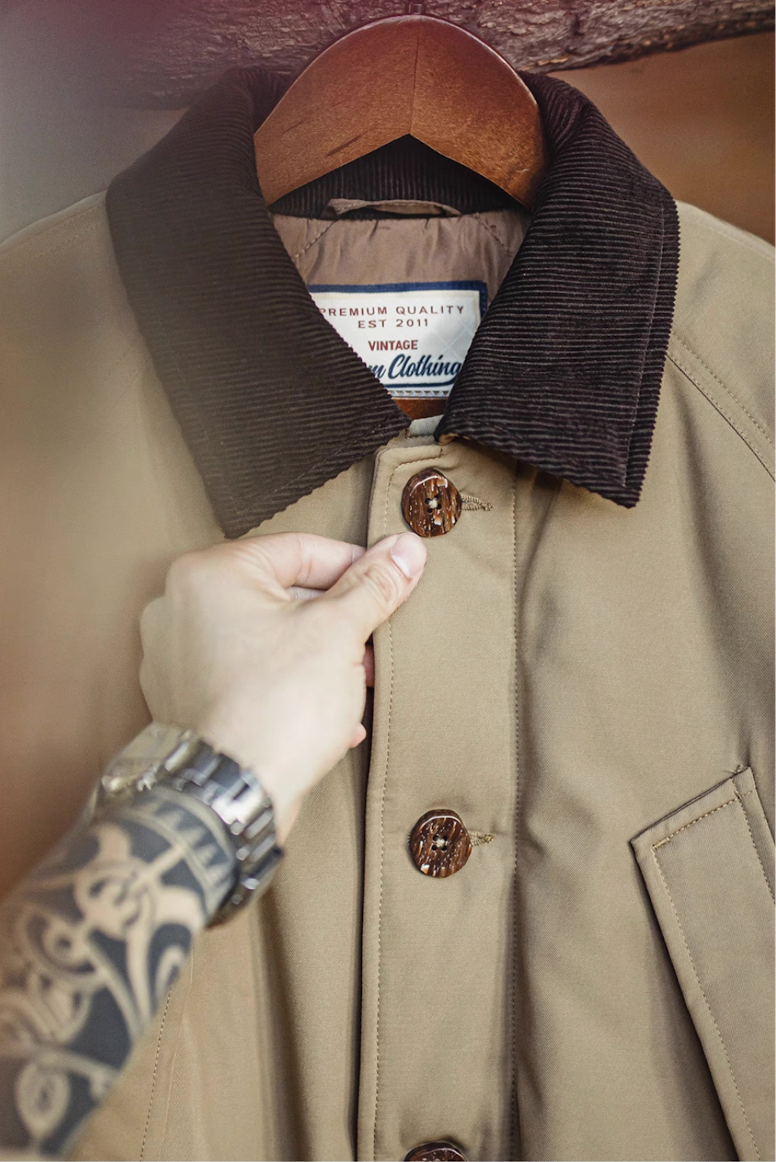 Close-up of corduroy collar and button stitching on khaki safari jacket