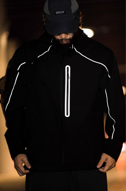 Model wearing black LIGHTSABER tech jacket in a dark urban tunnel