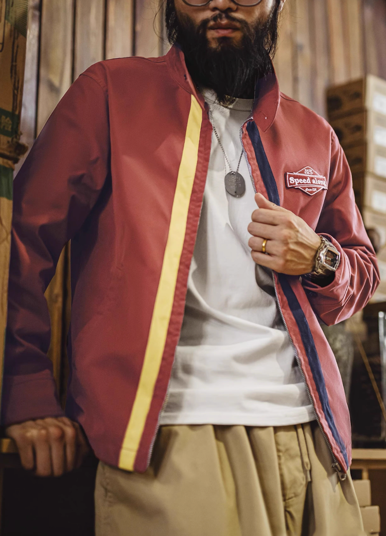Man wearing vintage brick red racing jacket with retro stripes and white tee