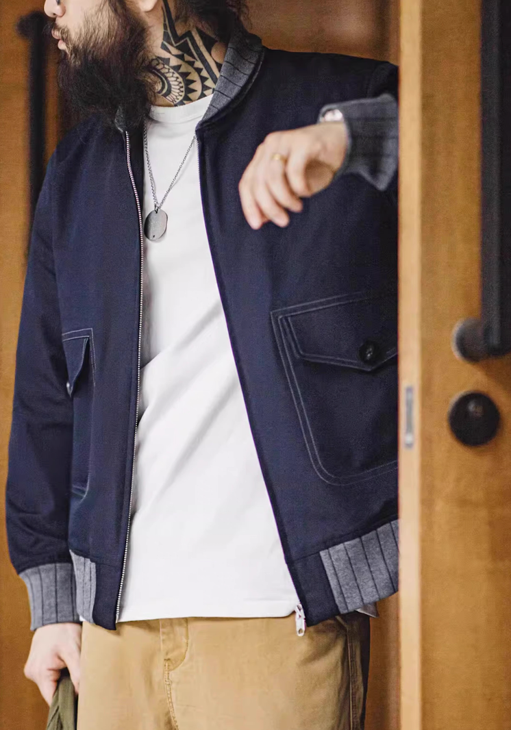 Man styling navy A1 bomber jacket over white T-shirt and khakis