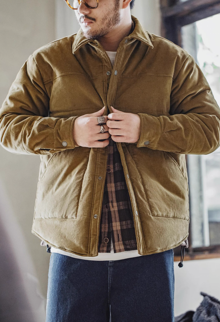 Man wearing earth yellow corduroy padded jacket with plaid shirt