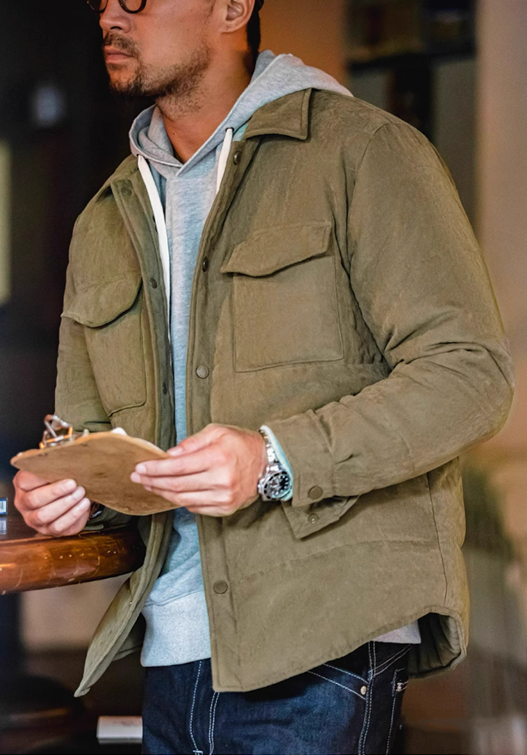 Model in Olive Green Softshell Shacket holding clipboard indoors