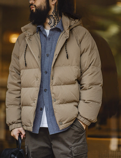Model wearing khaki Urban Shield Down Jacket styled with shirt and cargo pants