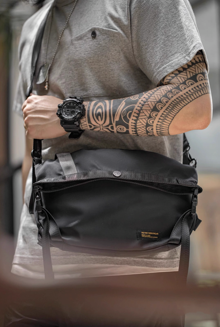 Model wearing Yama Style black crossbody cycling bag across chest