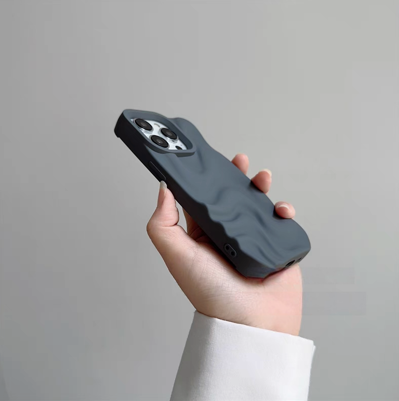 Gray 3D wave matte silicone phone case held at an angle highlighting slim profile and textured wave design