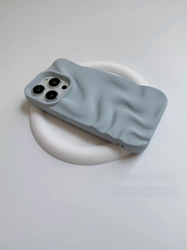 Light blue 3D wave matte silicone phone case angled on a white base highlighting raised edges and wave texture