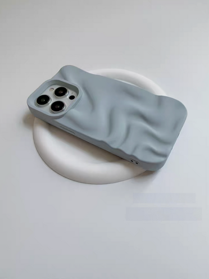 Light blue 3D wave matte silicone phone case angled on a white base highlighting raised edges and wave texture