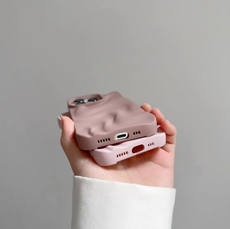 Light pink and dark pink silicone phone cases stacked showing bottom cutouts for charging port and speakers
