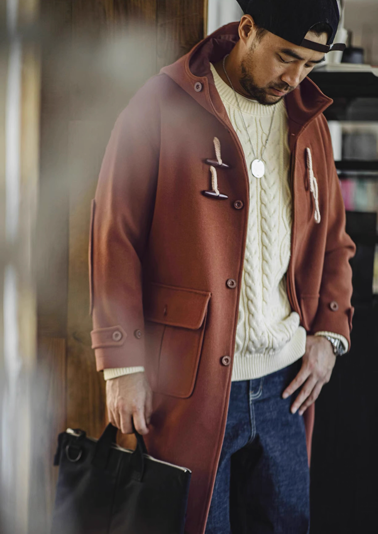 Model styling brown hooded duffle coat with jeans and cap