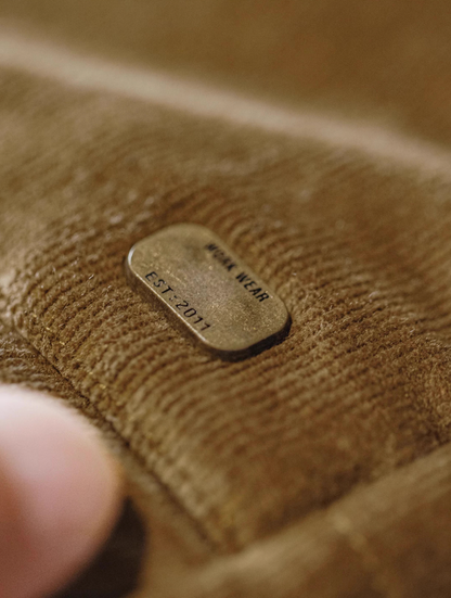 Close-up of fine-wale corduroy fabric texture in brown