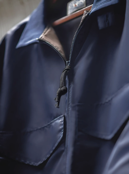 Close-up of zipper pull and nylon texture on G-8 Navy Flight Jacket, highlighting quality stitching.