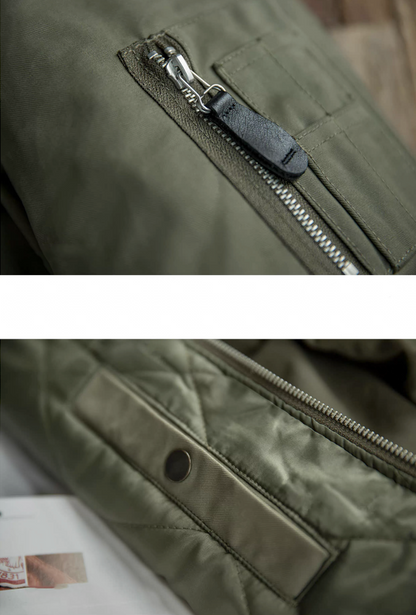 Close-up of zipper and pocket details on green B-15 flight jacket