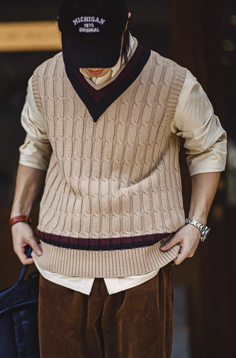 Man wearing Ivy-style khaki sweater vest layered over shirt and corduroy pants