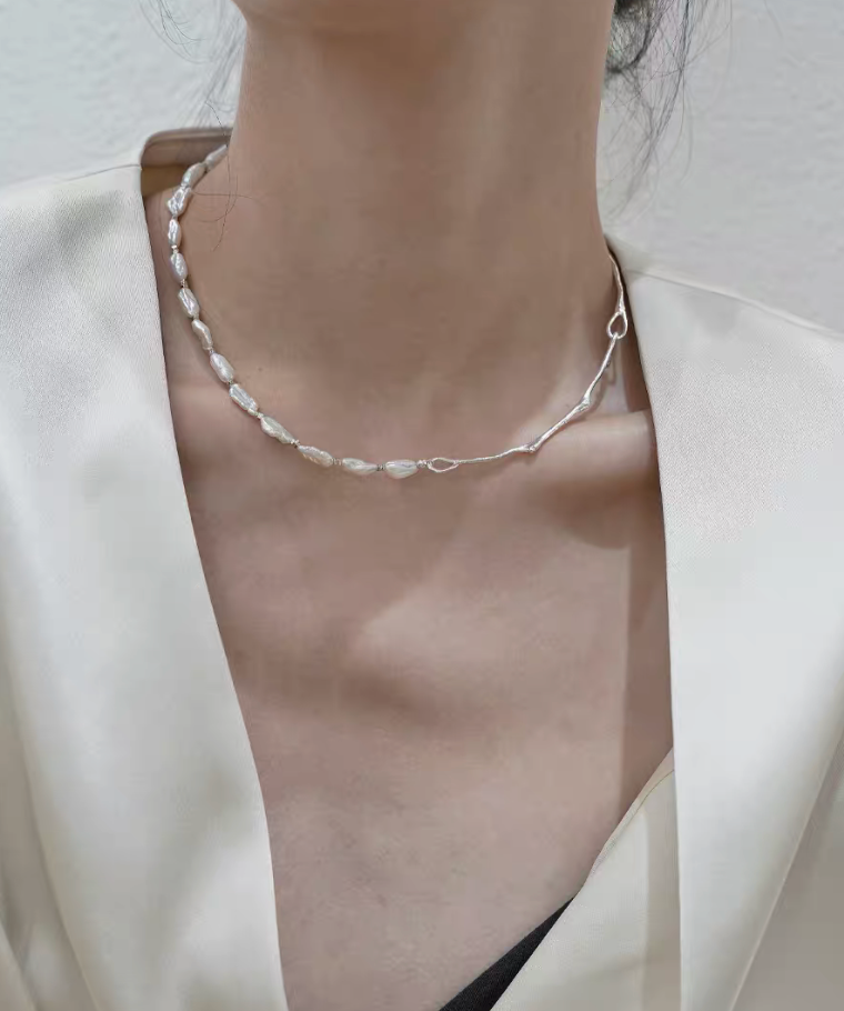 Model wearing Nature’s Grace baroque pearl branch necklace front view showing delicate asymmetrical pearl placement on neckline