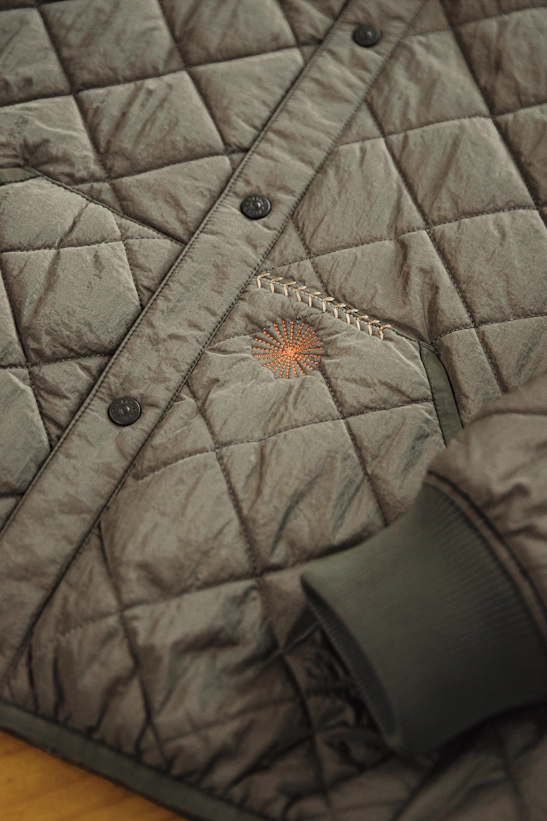 Close-up of diamond stitching and embroidered pocket detail
