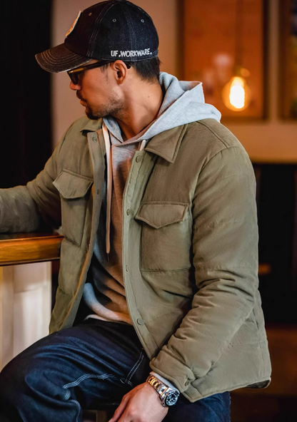 ide view of Olive Green Softshell Puffer Overshirt on model in café setting