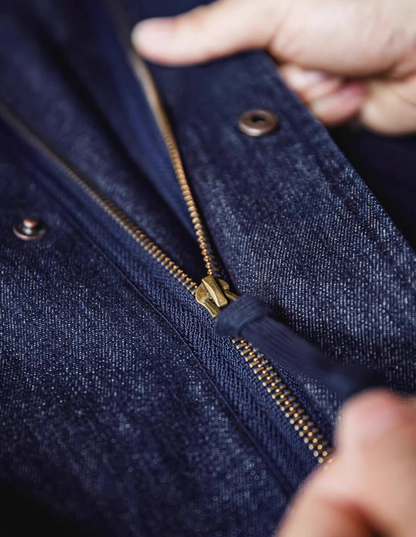 Close-up of brass zipper on premium denim fishtail parka