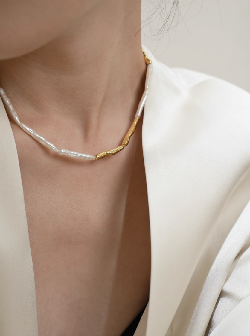 Side angle close-up of baroque pearl gold accent choker necklace showing textured gold element and natural pearl shapes