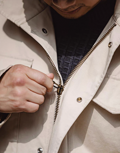 Close-up of durable metal zipper and snap placket on M65 Field Jacket
