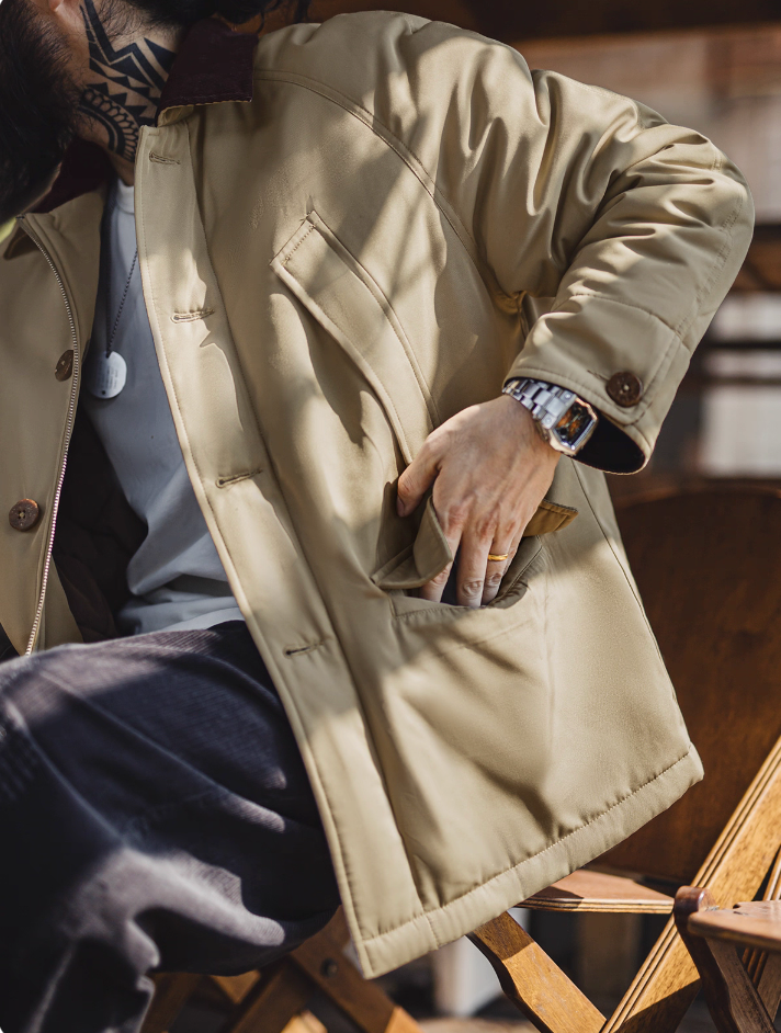 Model using front pocket of khaki workwear jacket with corduroy collar