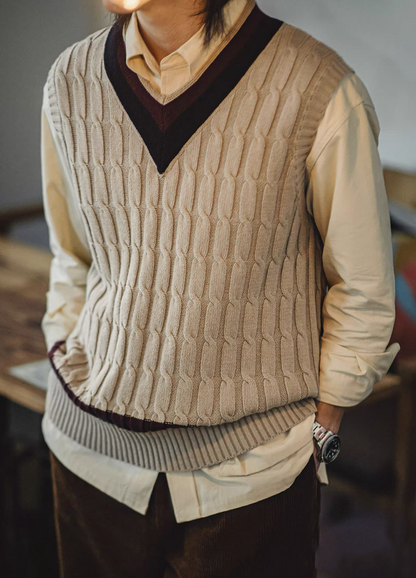 Man styling khaki cable knit vest indoors for casual fall look