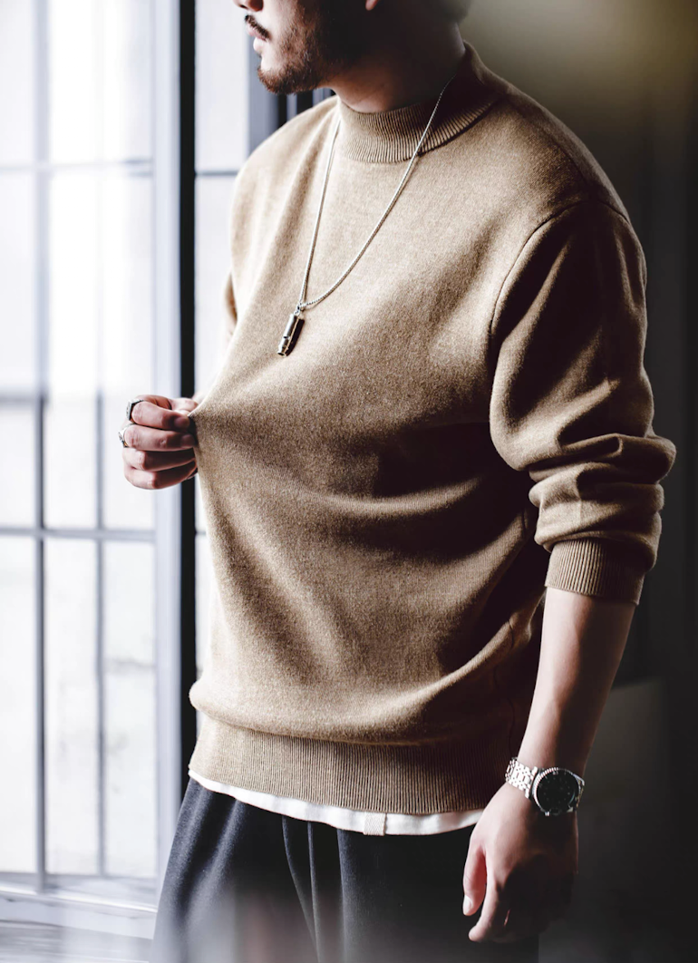 Model wearing sand beige half-turtleneck sweater with neutral outfit