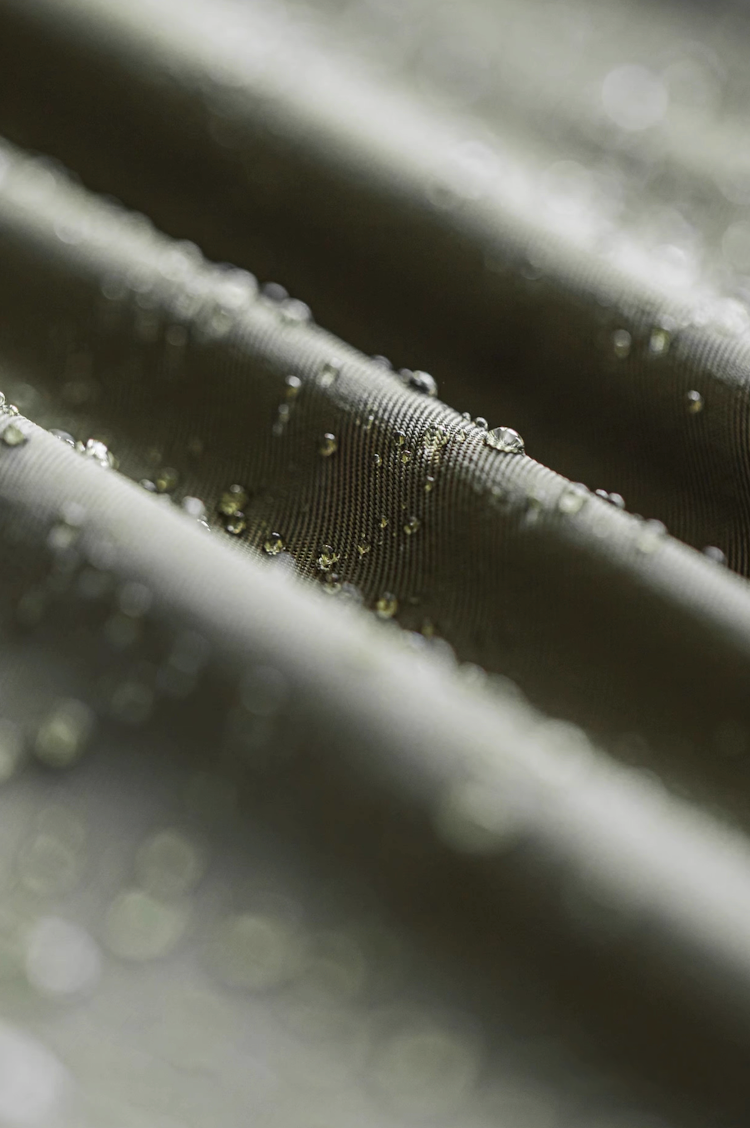Close-up water-resistant fabric texture with droplets on surface