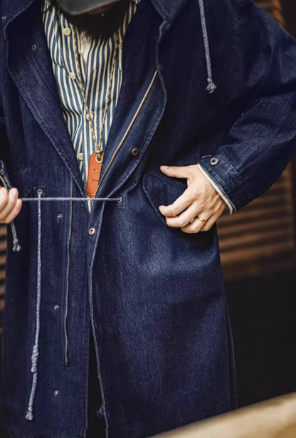 Model tightening drawcord waist on M-51 denim utility coat