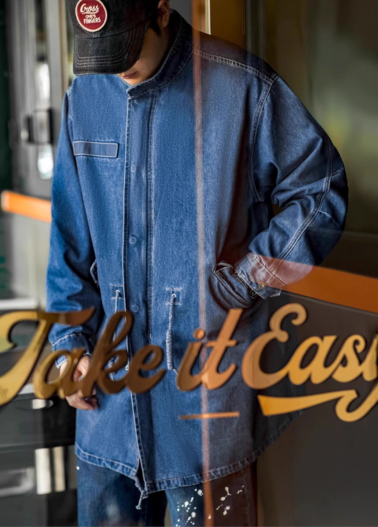 Denim military coat street reflection Take It Easy sign