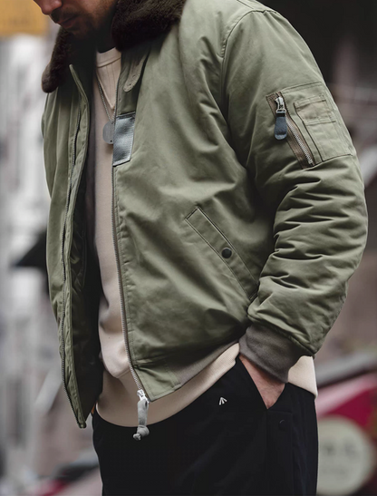 Side street view of green B-15 bomber jacket in casual outfit