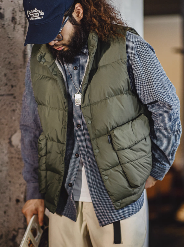 Model wearing Army Green Heritage Down Vest over check shirt