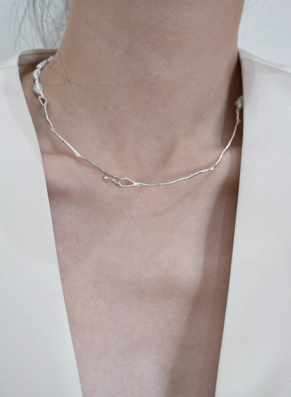 Model wearing Nature’s Grace baroque pearl branch necklace back view showing silver branch chain and clasp detail