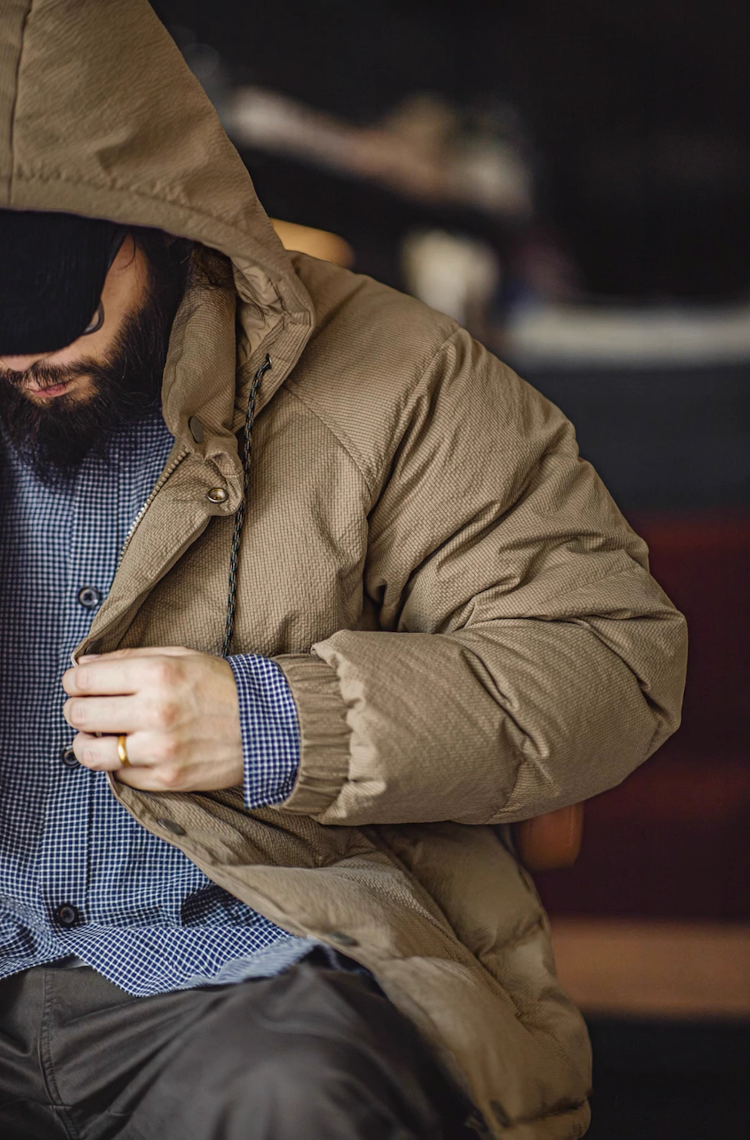 Model adjusting hood of khaki Urban Shield Down Jacket