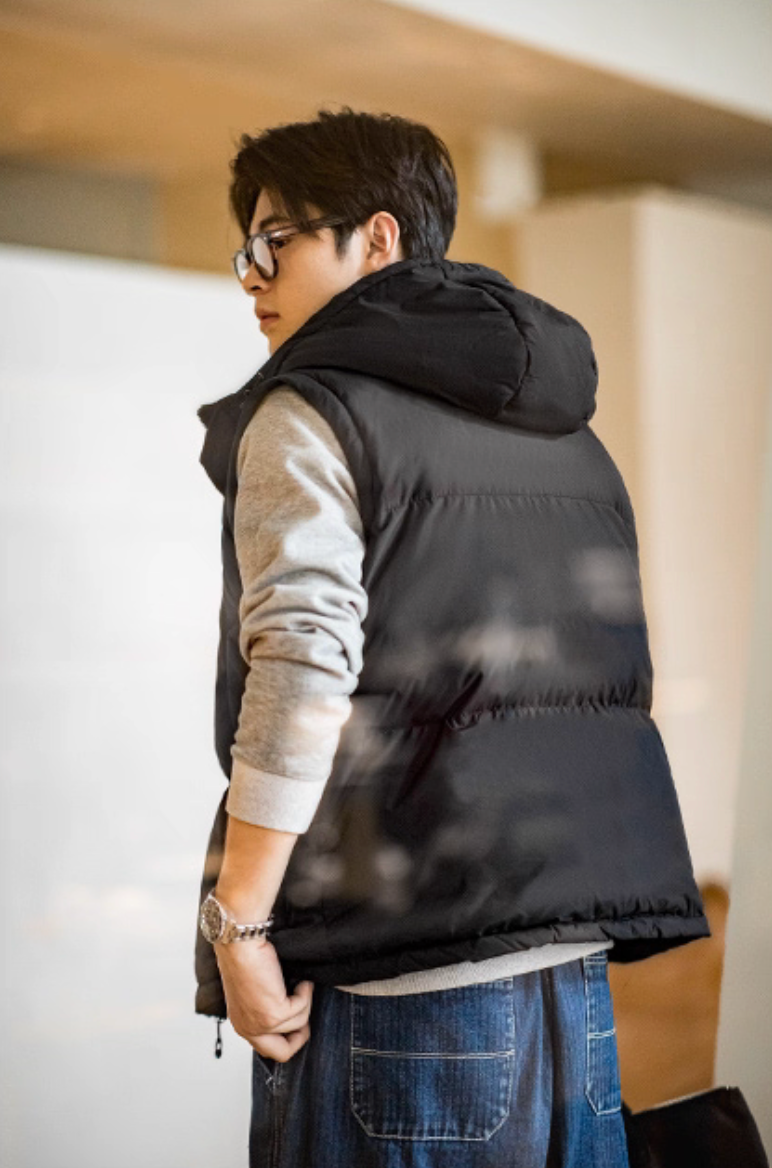 Back view of black hooded vest version showing down panel structure