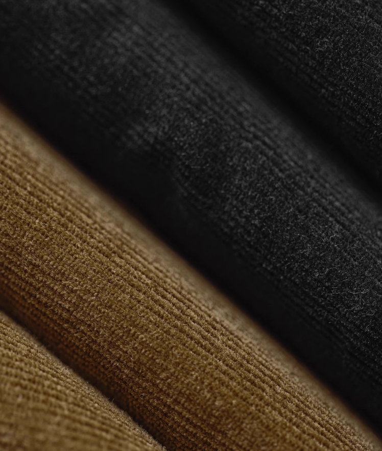 Black and brown corduroy fabric layers showing texture