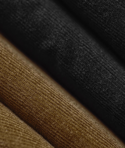 Black and brown corduroy fabric layers showing texture