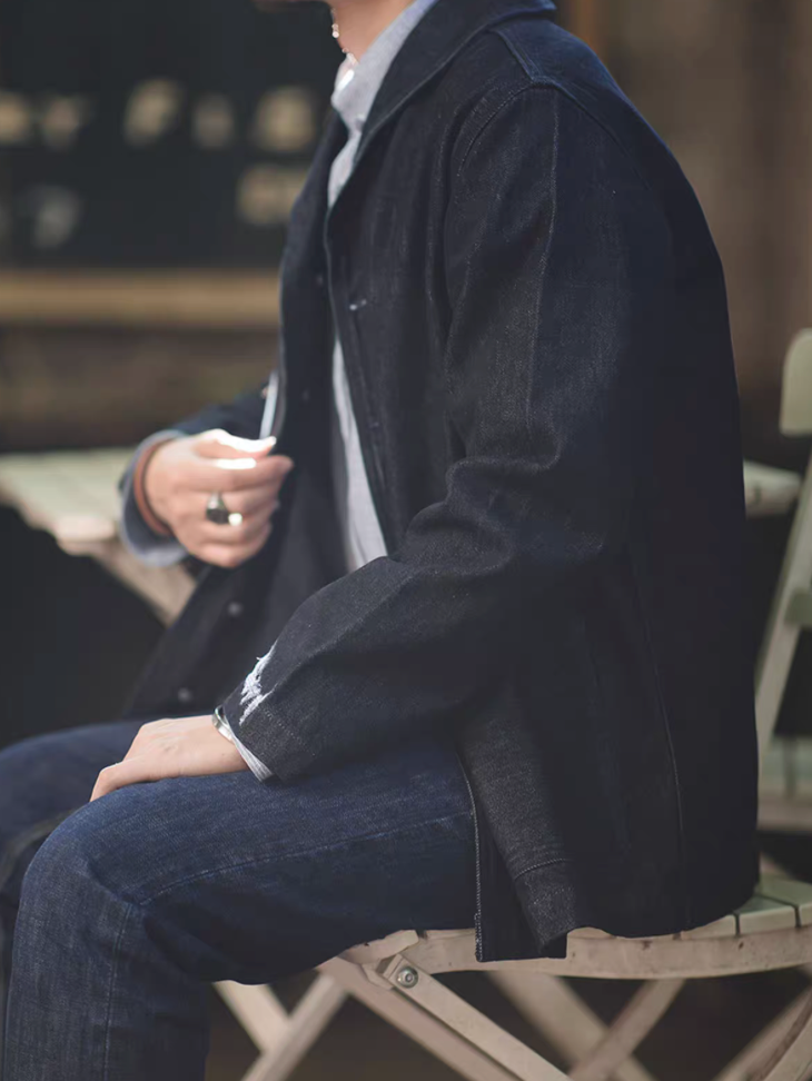 Model seated outdoors wearing Heritage Shawl-Collar Denim Jacket