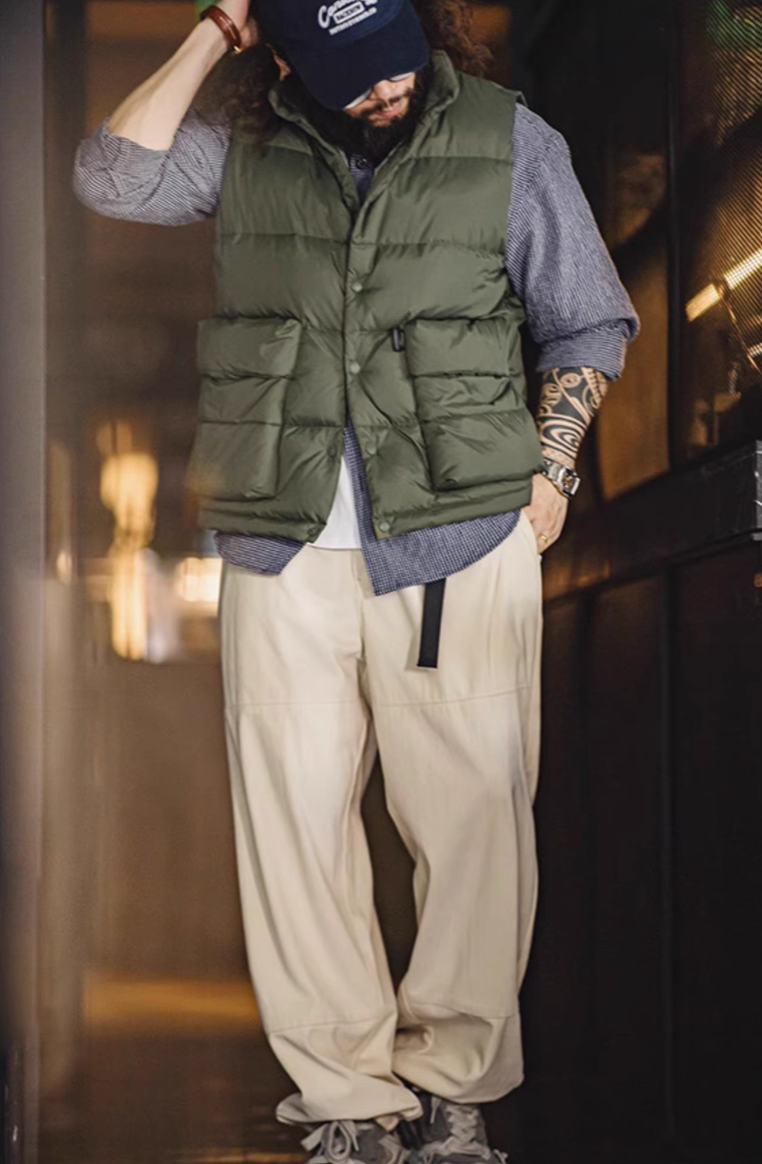 Full-body view of model in Army Green Heritage Down Vest and beige pants
