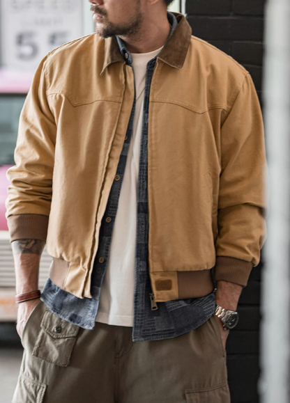 Model wearing khaki Santafe retro workwear jacket styled with denim overshirt.
