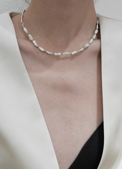 Model wearing Nature’s Grace baroque pearl branch necklace close-up focusing on baroque pearl segment across collarbone