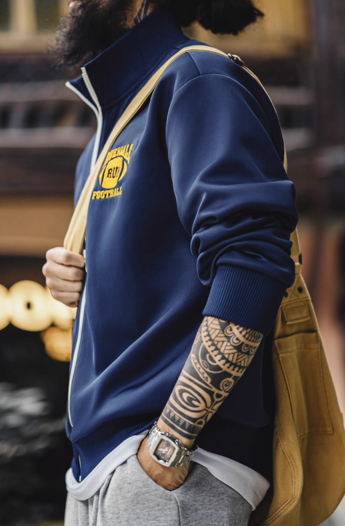 Close-up of sleeve and embroidered patch on Riverdale Run track jacket