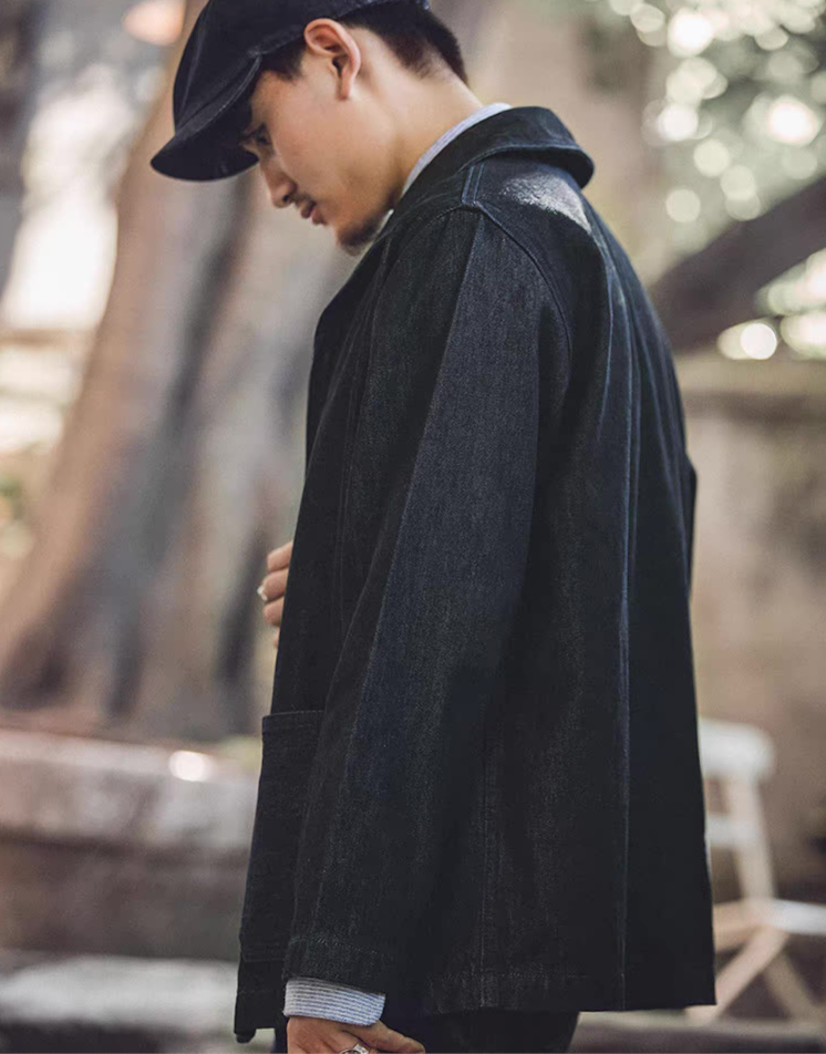Side profile of model wearing Heritage Shawl-Collar Denim Jacket in sunlight